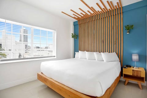 Wake up to sunshine and city views beside a plush bed.