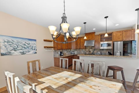 Rustic wooden dining table with seating for eight.