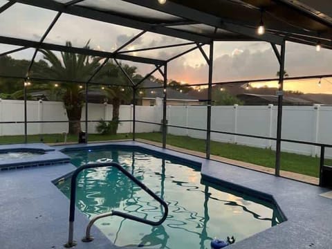 A peaceful pool setting during the evening sundown hours.