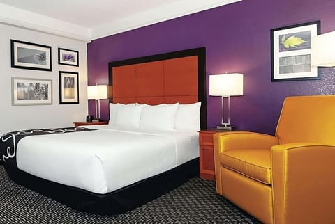 Unwind in a plush chair beside your perfectly made bed.
