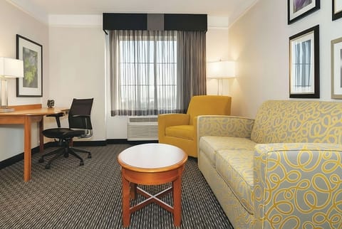Gather and recharge in a spacious sitting area with workspace.
