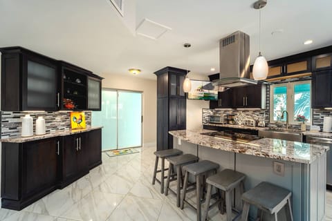 Engage in delightful family conversations while preparing dinner in this open-concept kitchen and dining space!