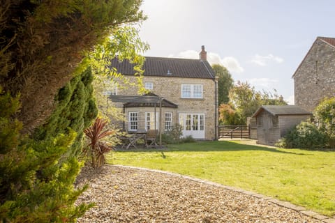 Saxon House, Harome: Large garden laid to lawn with seating area for guests to enjoy alfresco dining in the summer months