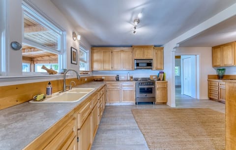 Fully equipped Kitchen with two sinks, two garbage disposals, and a gas stove. 
