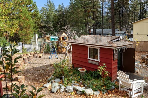 Spacious backyard with a swing set and playhouse, perfect for kids to play and explore.