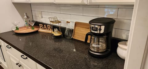 Coffee bar area with drip coffee maker and charcuterie board. 
