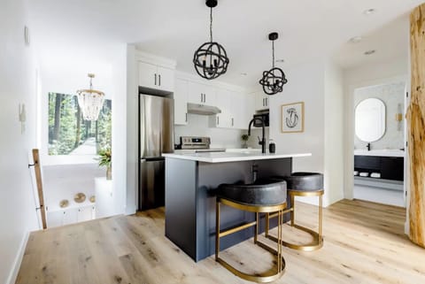 Bright Modern Boho Kitchen with Quartz countertops & undercabinet lighting.