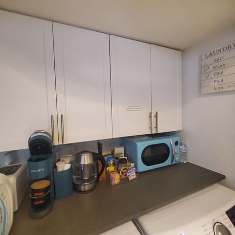 Inside kitchenette,kettle , coffee maker,toaster , microwave, coffee,tea spices 