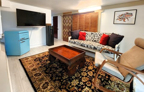 Lower level livingroom with large screen TV, water cooler and mini fridge.