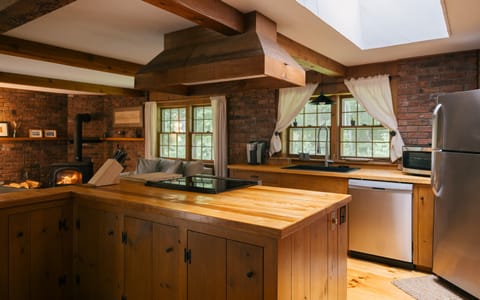 Open-concept kitchen with all custom woodworking and modern appliances.