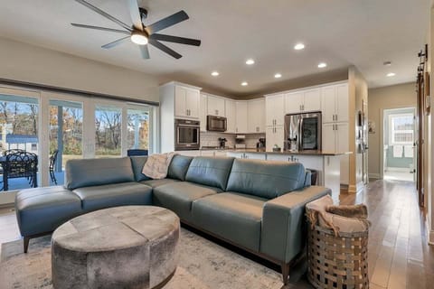 An open living space with sectional seating flowing into the kitchen.