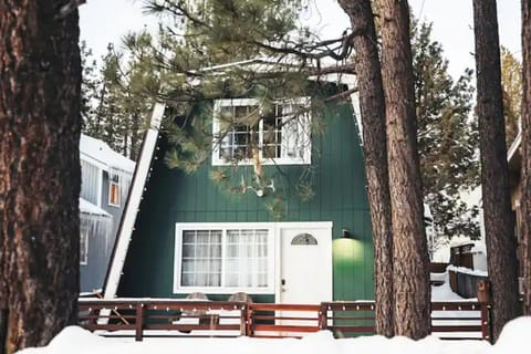 Our little green cabin, nestled among the trees.