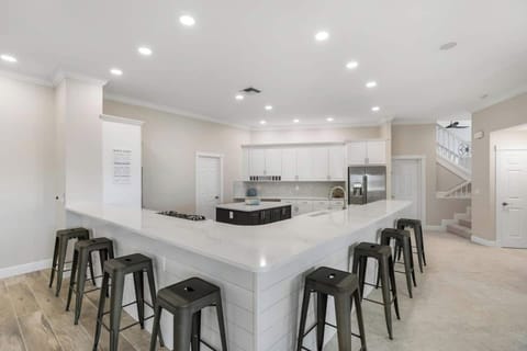 A Stunning and Spacious Kitchen with Gas Range, Stainless Appliances, Walk-In Pantry and Seating for 8.