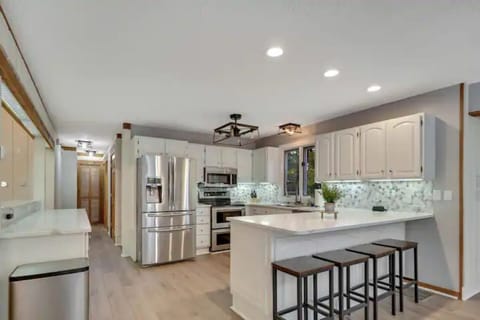 Newly remodeled, fully stocked kitchen with view down the hallway.