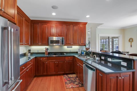 Large kitchen with four burners, large fridge, microwave, dishwasher...