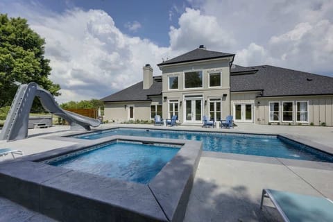 Huge private pool, spa, with waterslide, multiple lounge area, covered BBQ patio, fully fenced yard, putting green, and so much more!