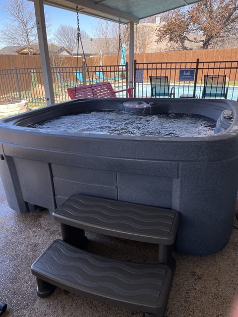 5 seat hot tub under covered patio to enjoy along with swimming pool