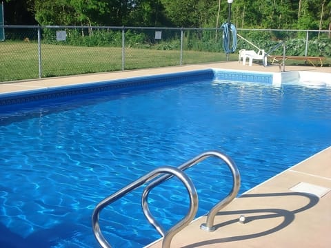 Dive into sparkling blue waters under warm afternoon sun.