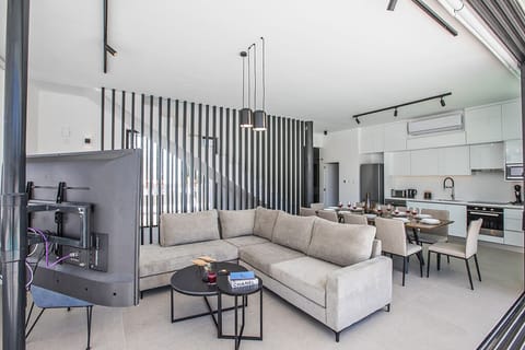 Living room wtih comfortable seating areas and widescreen TV