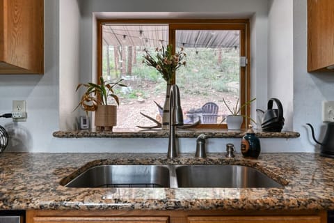 The kitchen looks out into the back yard