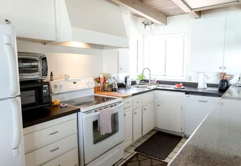 A new viking   type of gas stove has been added and a new side by side refrigerator has been added since this photo. This 1972kitchen remains unchanged and is a bit cumbersome and small but very functional. The six seat counter top makes it a favorite pla