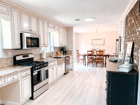 Fully stocked kitchen with stainless steel appliances and granite countertops.