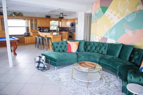 We were so excited about getting this retro green velour couch to match style and vibe of this beachy boho waterfront home.  It is so comfortable, too!  The living room is set up perfectly for spacious lounging- as well and dolphin watching!