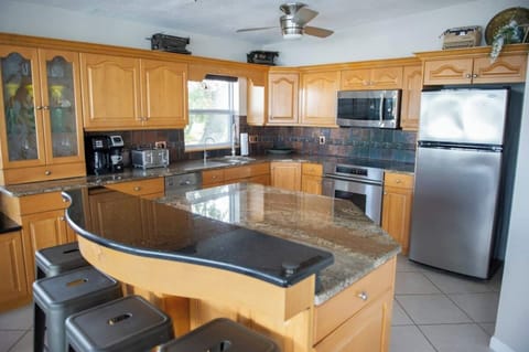 This spacious kitchen is fully stocked with all of your cooking needs.  Appliances include a stove, oven, microwave, blender, mini magic bullet, and toaster.  We also provide a complete set of plates, bowls, glasses,  wine glasses, mugs, & utensils.