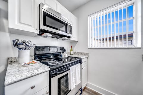 Fully stocked kitchen with glass top gas burner and oven