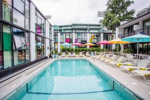 Dive into a sunlit pool framed by colorful modern design.