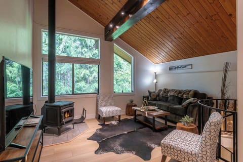 Gather in the cozy living room with comfortable furnishings, rustic charm, and a warm atmosphere perfect for relaxing after exploring.