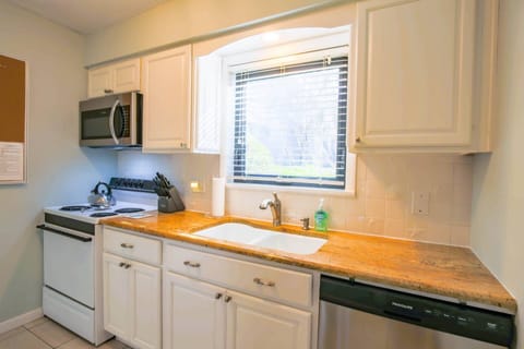 The kitchen has a range, microwave, dishwasher and refrigerator.