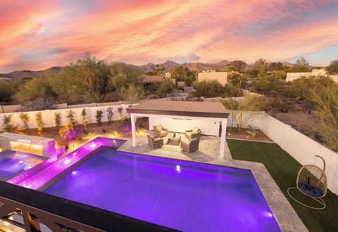 Dive into luxury: resort pool, hot tub, & stunning mountain sunset views.