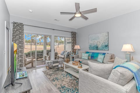 Main Villa living room with patio overlooking green on Byrd hole 16