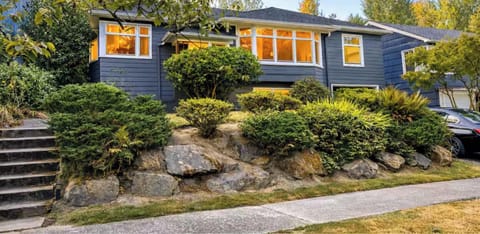 Charming hillside home surrounded by lush greenery, offering a warm welcome and peaceful neighborhood feel the moment you arrive.