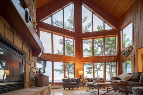Floor-to-ceiling windows framing endless Lake Superior views from inside the cabin — wake up to this every morning at The Bear Den