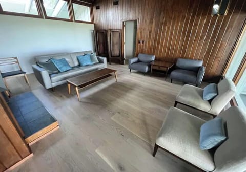 living room with cathedral ceiling, water views