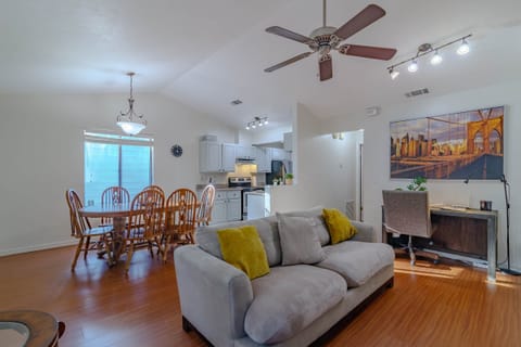 Living room with dining room view.The sofa converts into a bed