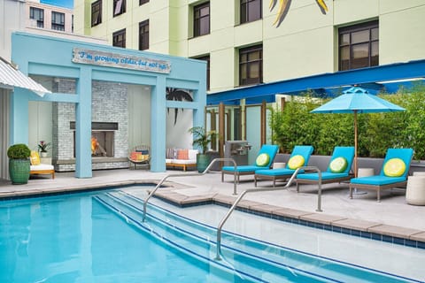 Unwind poolside by the fireplace with colorful loungers.