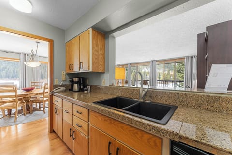 Full kitchen with granite countertops and stainless steel appliances.
