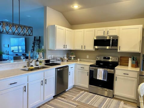 Full kitchen — dishwasher, garbage disposal, refrigerator with ice maker and water dispenser, and microwave/range. 