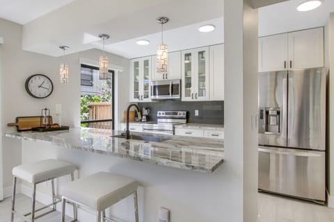 Stunning newly renovated kitchen with bar stool seating.