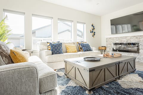 Living room features board games, electric fireplace and 70" Smart TV with cable