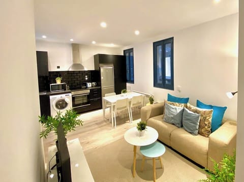 General view of the living room with kitchen in the background
