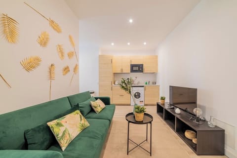General view of the living room with the kitchen in the background