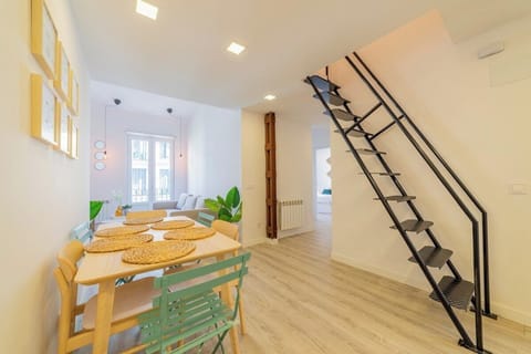 General view of the living room with access to the balcony and stairs to the upper bedroom