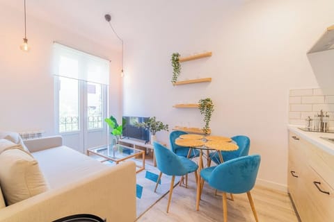 General view of the living room with kitchen in the background and access to the balcony