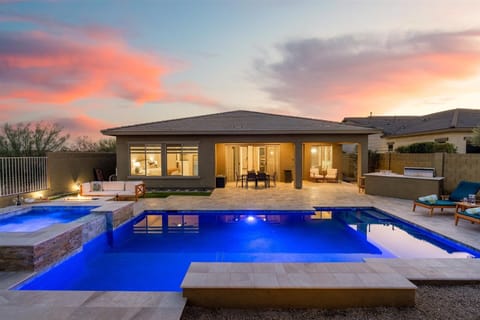Backyard Oasis | Gas-Heated Pool, Hot Tub & Putting Green Relax in your private outdoor retreat featuring a heated pool, hot tub, and putting green, all with stunning desert sunset views.