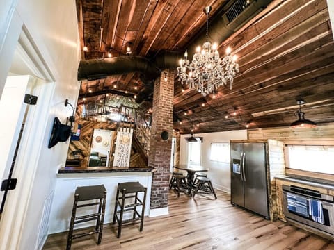 Where rustic meets refined- cook, gather, and dine under the sparkle of a chandelier.