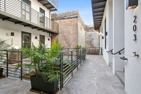 Elegant, private courtyard patio with natural light and exposed brick